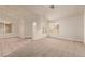 Bright living room with a combination of tile and carpet flooring, plus many windows for light at 178 Beach Oak Ave, Henderson, NV 89002