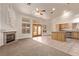 Open-concept living area with a fireplace, glass doors to the outside, and a view of the kitchen, great for gatherings at 178 Beach Oak Ave, Henderson, NV 89002