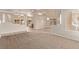 Spacious living room with tile and carpet flooring and an open design to the dining area at 178 Beach Oak Ave, Henderson, NV 89002