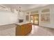 Open living space with fireplace, kitchen island and a view of the outdoors, great for entertaining and everyday living at 178 Beach Oak Ave, Henderson, NV 89002