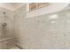 Shower features stone walls and a built-in bench, enhancing the spa-like ambiance at 178 Beach Oak Ave, Henderson, NV 89002