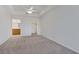 Bright bedroom featuring neutral carpet, a ceiling fan, and access to a bathroom and closet at 19 E Agate Ave # 402, Las Vegas, NV 89123
