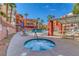 Hot tub with lounge chairs, palm trees, and complex buildings in the background at 19 E Agate Ave # 402, Las Vegas, NV 89123