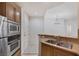 Bright kitchen features stainless appliances, granite countertops, and wood cabinetry at 19 E Agate Ave # 402, Las Vegas, NV 89123