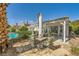 Lush backyard with a pool, covered patio, and comfortable seating amidst beautiful landscaping at 2012 Lady Lake St, Las Vegas, NV 89128