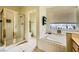 Bathroom showcasing a tiled shower, a separate toilet room, and a tub under a window at 2012 Lady Lake St, Las Vegas, NV 89128