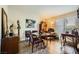 Cozy dining room with a round glass table, eclectic decor, and a window with blinds at 2012 Lady Lake St, Las Vegas, NV 89128
