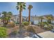 Charming single-story home features palm trees, a well-manicured lawn, and a welcoming facade at 2012 Lady Lake St, Las Vegas, NV 89128