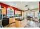 Bright eat-in kitchen featuring stone floors, light cabinets, and breakfast nook area at 2012 Lady Lake St, Las Vegas, NV 89128