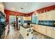 Well-lit kitchen with stone floors, stainless steel appliances, and dark countertops at 2012 Lady Lake St, Las Vegas, NV 89128
