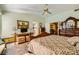 Sunlit main bedroom with a detailed bed frame, desk, and seating, creating a cozy retreat at 2012 Lady Lake St, Las Vegas, NV 89128
