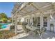 Relaxing poolside patio with comfortable seating under a pergola, perfect for outdoor entertainment at 2012 Lady Lake St, Las Vegas, NV 89128