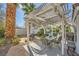 Inviting poolside patio with shaded pergola, outdoor seating, and lush tropical landscaping at 2012 Lady Lake St, Las Vegas, NV 89128