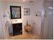Traditional bathroom with a dark vanity, black framed mirror, and white toilet and shower at 2058 Ottawa Dr, Las Vegas, NV 89169