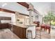 Open kitchen design with breakfast bar, wood beams, and modern stainless steel appliances at 2058 Ottawa Dr, Las Vegas, NV 89169