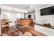 Inviting living room features a wet bar with wood floors, bar stools, and a large flat screen TV at 2058 Ottawa Dr, Las Vegas, NV 89169
