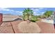Spacious backyard with desert landscaping, gravel, lawn, and views of the community at 2077 Wildwood Lake St, Henderson, NV 89052