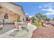 Backyard featuring a covered patio, outdoor seating, landscaping, and desert rock at 2077 Wildwood Lake St, Henderson, NV 89052