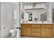 Bathroom featuring a double sink vanity, toilet, and glass enclosed shower with bench at 2077 Wildwood Lake St, Henderson, NV 89052