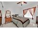 Cozy bedroom with neutral decor, a ceiling fan, and natural light from the window at 2077 Wildwood Lake St, Henderson, NV 89052