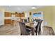 Eat-in kitchen and dining room featuring wood floors and plenty of sunlight at 2077 Wildwood Lake St, Henderson, NV 89052