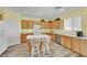 Bright kitchen with stainless steel appliances, laminate floors, wood cabinets, and a large center island at 2077 Wildwood Lake St, Henderson, NV 89052