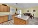 Bright kitchen with stainless steel appliances, laminate floors, wood cabinets, and access to the backyard at 2077 Wildwood Lake St, Henderson, NV 89052