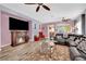 Bright living room with a fireplace, wood floors, and comfortable seating at 2077 Wildwood Lake St, Henderson, NV 89052