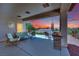 Covered patio with a seating area, grill, and a view of the yard and mountains at 2077 Wildwood Lake St, Henderson, NV 89052