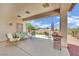 Covered patio with outdoor seating, a grill, and a well-maintained landscape at 2077 Wildwood Lake St, Henderson, NV 89052