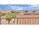 View of a desert landscape with a terracotta tile roof featuring solar panels against a backdrop of picturesque mountains at 2077 Wildwood Lake St, Henderson, NV 89052