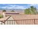 View of desert landscape with terra-cotta tile roofs featuring solar panels against a backdrop of picturesque mountains at 2077 Wildwood Lake St, Henderson, NV 89052