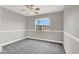 This neutral bedroom offers ample space, ceiling fan, and a bright window at 2106 Polynesia Cir, Henderson, NV 89074