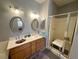 Modern bathroom features double sinks, oak cabinets, and a walk-in shower with a seat at 2270 Canyon Song Ave, Laughlin, NV 89029