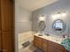 Well-lit bathroom equipped with double sinks, oak cabinets, and a tub at 2270 Canyon Song Ave, Laughlin, NV 89029