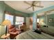 Bedroom featuring mirrored closet doors, seating, and a ceiling fan for added comfort at 2270 Canyon Song Ave, Laughlin, NV 89029