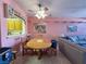 Cozy dining area features a wooden table, ceiling fan and pass-through to kitchen at 2270 Canyon Song Ave, Laughlin, NV 89029