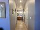 Hallway leading to a bathroom with double sinks, mirrored and oak cabinets at 2270 Canyon Song Ave, Laughlin, NV 89029