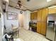 Eat-in kitchen featuring tile flooring, wooden cabinets, stainless steel appliances, and a breakfast nook area at 2270 Canyon Song Ave, Laughlin, NV 89029