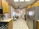 Bright kitchen featuring tile flooring, stainless steel appliances, and wooden cabinets with a breakfast nook in the background at 2270 Canyon Song Ave, Laughlin, NV 89029
