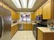 The kitchen features stainless steel appliances, wooden cabinets and a view to the living room at 2270 Canyon Song Ave, Laughlin, NV 89029