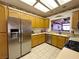 This kitchen features stainless steel appliances, wooden cabinets and a view to the living room at 2270 Canyon Song Ave, Laughlin, NV 89029