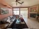 Bright living room showcasing a fireplace, tiled floors, and a comfortable leather sofa at 2270 Canyon Song Ave, Laughlin, NV 89029
