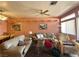 Cozy living room featuring two couches, a glass coffee table, and a decorative ceiling fan at 2270 Canyon Song Ave, Laughlin, NV 89029