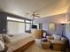 Spacious main bedroom with a comfortable bed, ample natural light, and ceiling fan at 2270 Canyon Song Ave, Laughlin, NV 89029