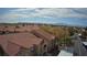 Panoramic aerial view of community with tile roofs, well-maintained grounds, and a view of the mountains at 2300 E Silverado Ranch Blvd # 1070, Las Vegas, NV 89183