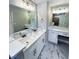Bathroom with dual sinks, marble counters, modern fixtures and marbled floor at 2428 Greens Ave, Henderson, NV 89014
