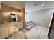 Modern bathroom featuring double sinks, white cabinets, marble countertops and floors, and a soaking tub at 2428 Greens Ave, Henderson, NV 89014