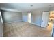 Bright bedroom featuring soft carpet, neutral walls, and easy access to the bathroom at 2428 Greens Ave, Henderson, NV 89014