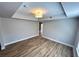 Spacious bedroom featuring durable wood flooring, ample natural light, and modern ceiling fan at 2428 Greens Ave, Henderson, NV 89014